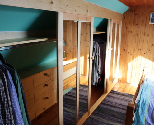 pine wardrobe with internal drawers fitted in coombed ceiling